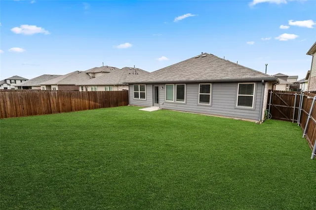 a view of a house with a yard and sitting area