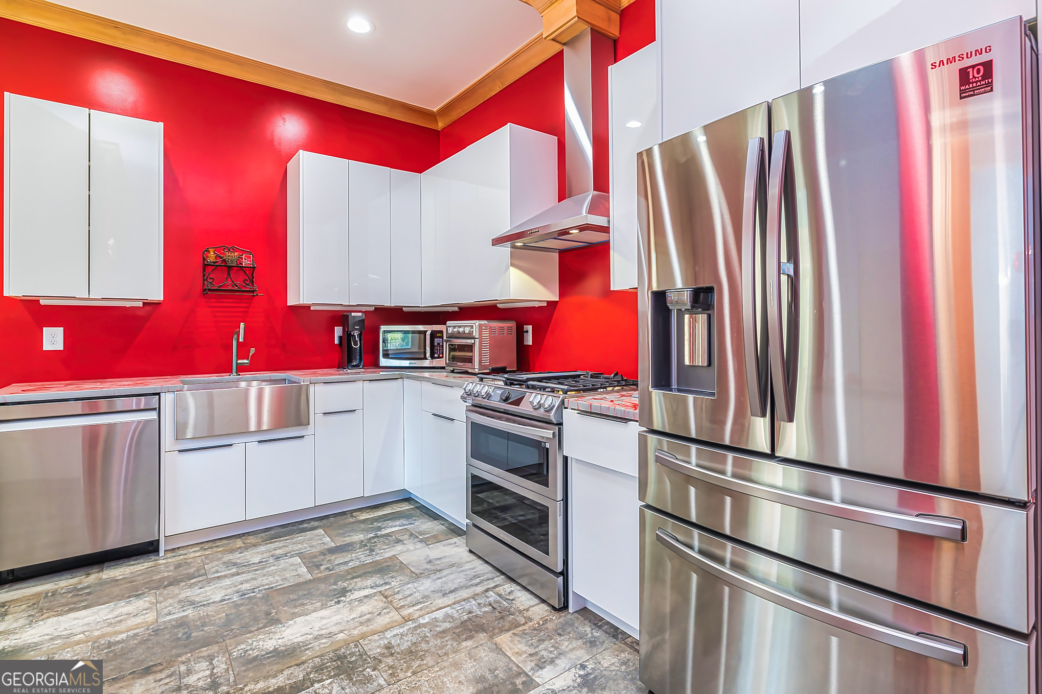 242 Kirkley Road Tyrone, GA 30290 - Photo 47 of 50 a kitchen with white cabinets and stainless steel appliances