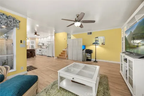 a living room with stainless steel appliances kitchen island granite countertop furniture and a fireplace
