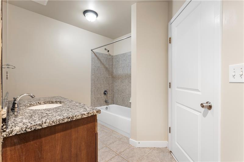 250 Pharr Road Northeast, Unit 308 Atlanta, GA 30305 - Photo 13 of 35 a bathroom with a granite countertop sink and a mirror