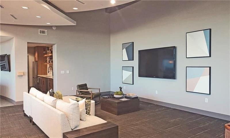 250 Pharr Road Northeast, Unit 308 Atlanta, GA 30305 - Photo 28 of 35 a living room with furniture and a flat screen tv