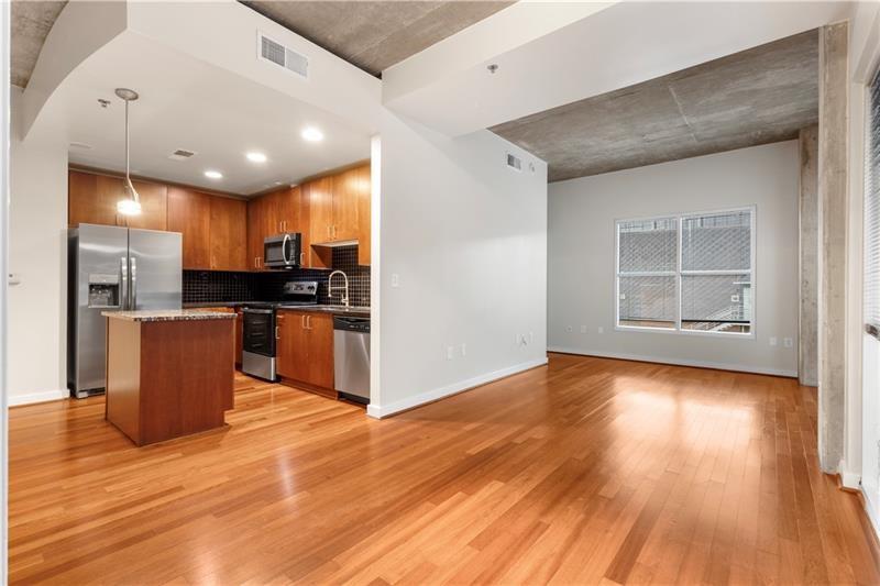250 Pharr Road Northeast, Unit 308 Atlanta, GA 30305 - Photo 5 of 35 a view of kitchen with cabinets and wooden floor