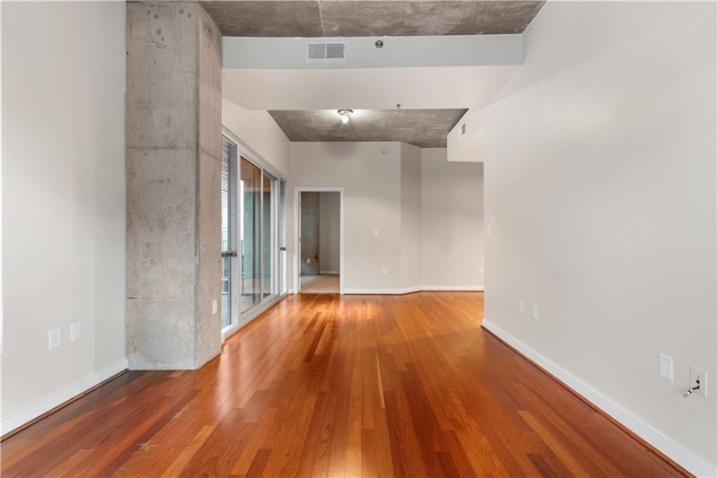 250 Pharr Road Northeast, Unit 308 Atlanta, GA 30305 - Photo 6 of 35 a view of an empty room with wooden floor