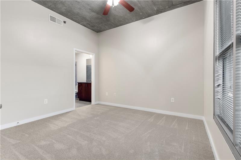 250 Pharr Road Northeast, Unit 308 Atlanta, GA 30305 - Photo 7 of 35 an empty room with a empty space and a window