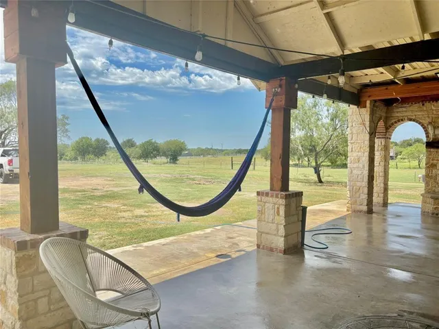 a swimming pool with large glass windows and painted walls