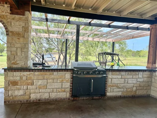 a stove top oven sitting inside of a kitchen