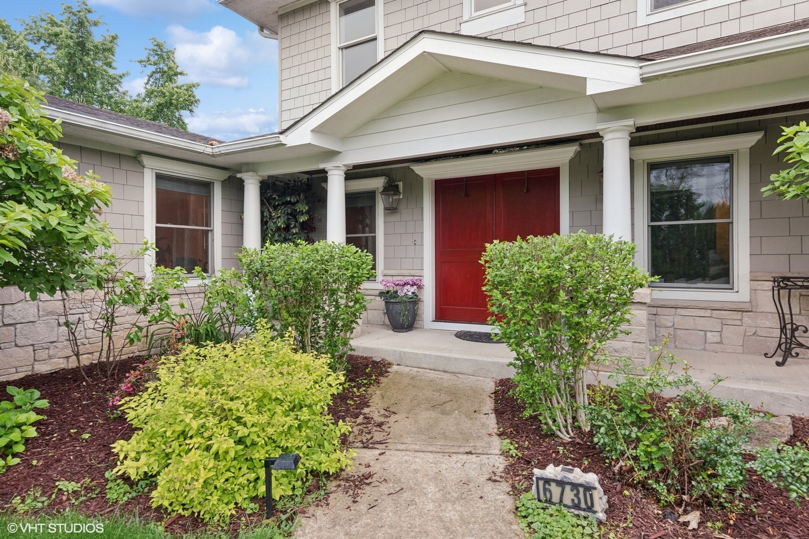front view of the house with potted plants