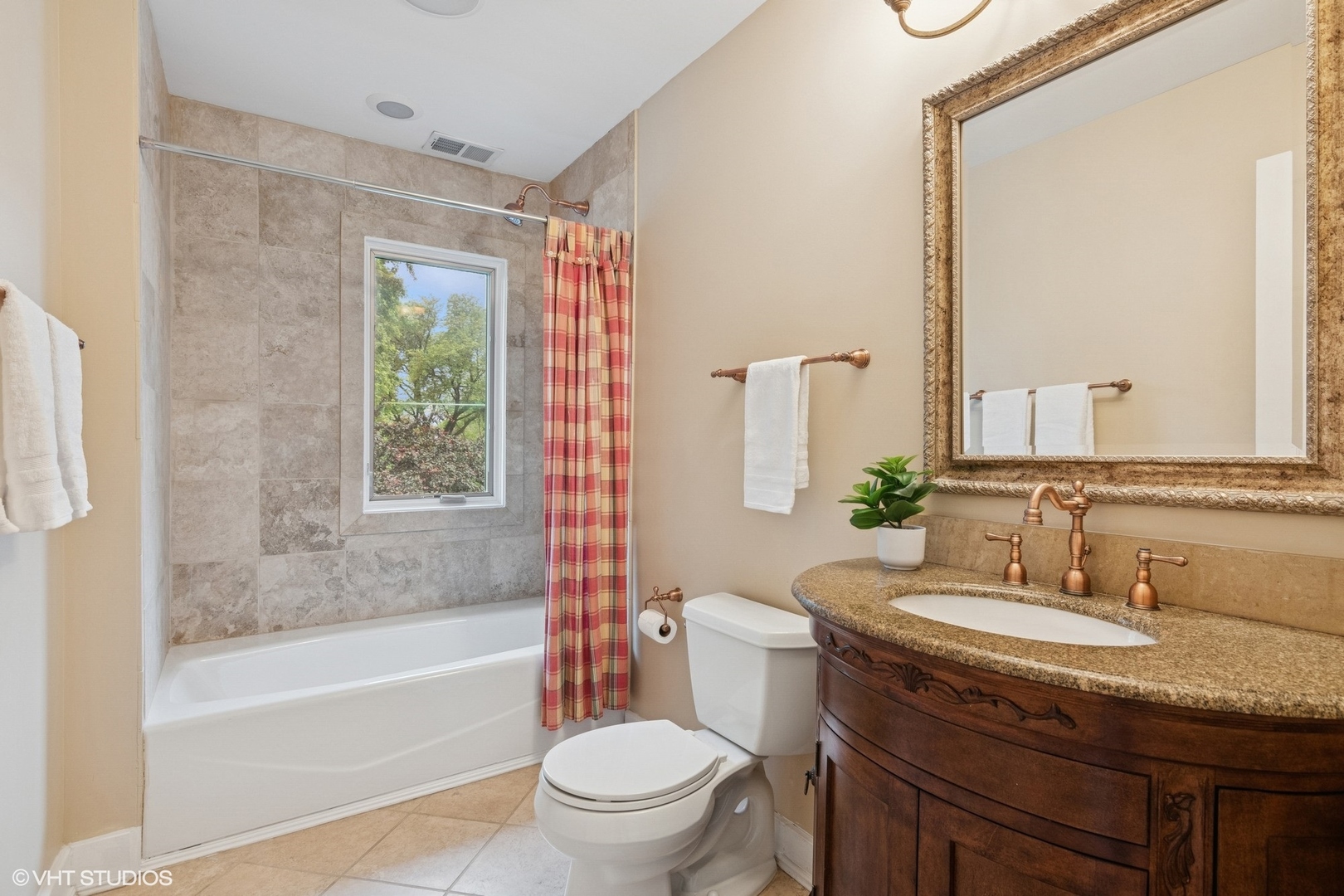 6730 South Madison Street Willowbrook, IL 60527 - Photo 32 of 52 a bathroom with a granite countertop sink a toilet a mirror and a tub