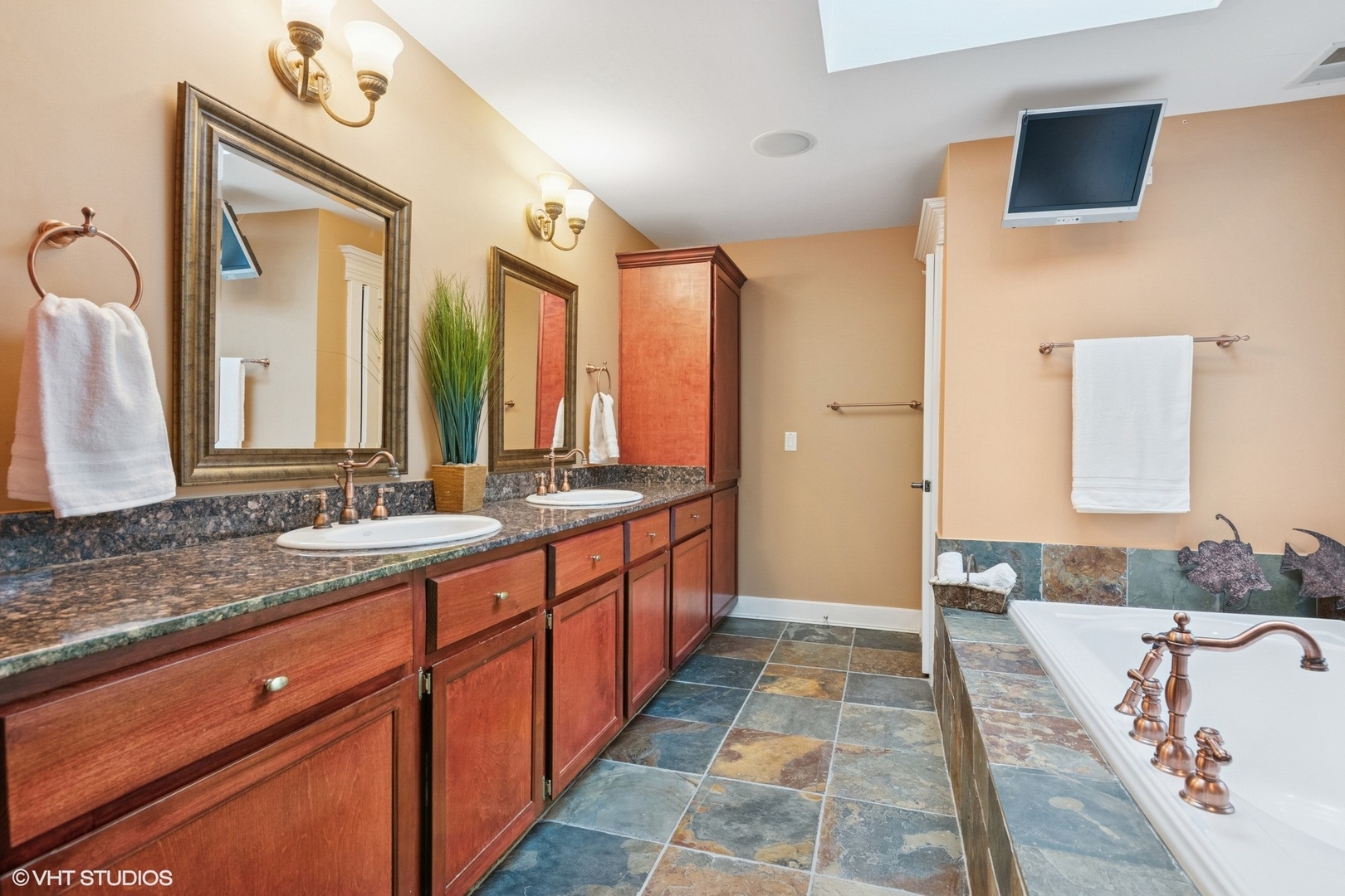 6730 South Madison Street Willowbrook, IL 60527 - Photo 38 of 52 a spacious bathroom with a double vanity sink a mirror and a bathtub