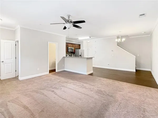 a view of a kitchen with a sink and a refrigerator