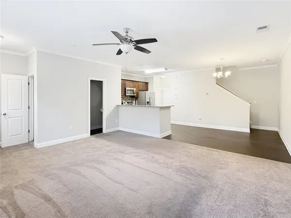 a view of a kitchen with a sink and a refrigerator