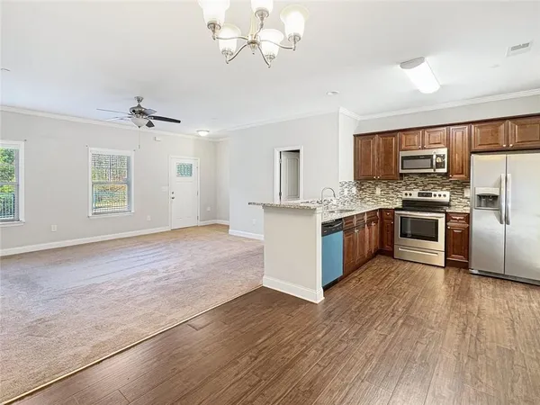 a kitchen with stainless steel appliances a stove top oven and refrigerator