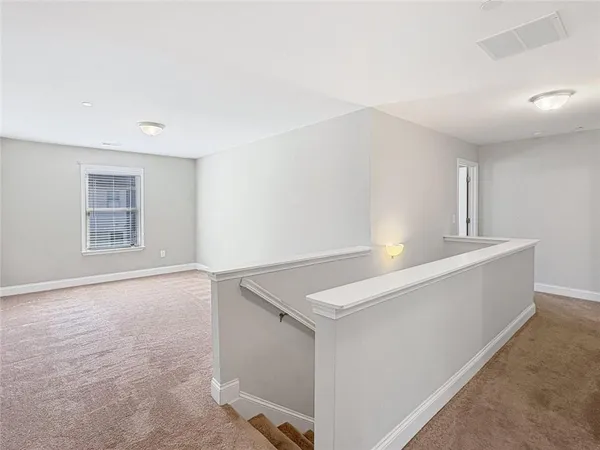 a view of an empty room with windows