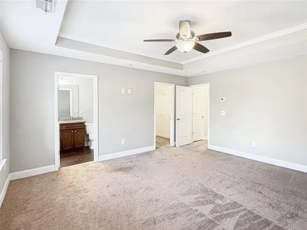 a view of an empty room and a ceiling fan
