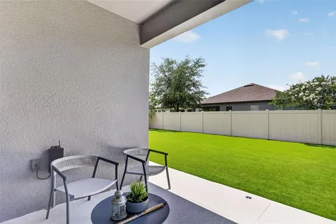a living room with furniture and a kitchen area