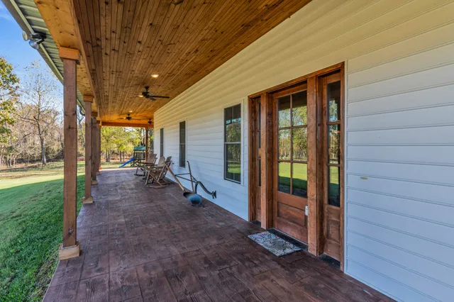 a view of a porch with wooden floor and roof