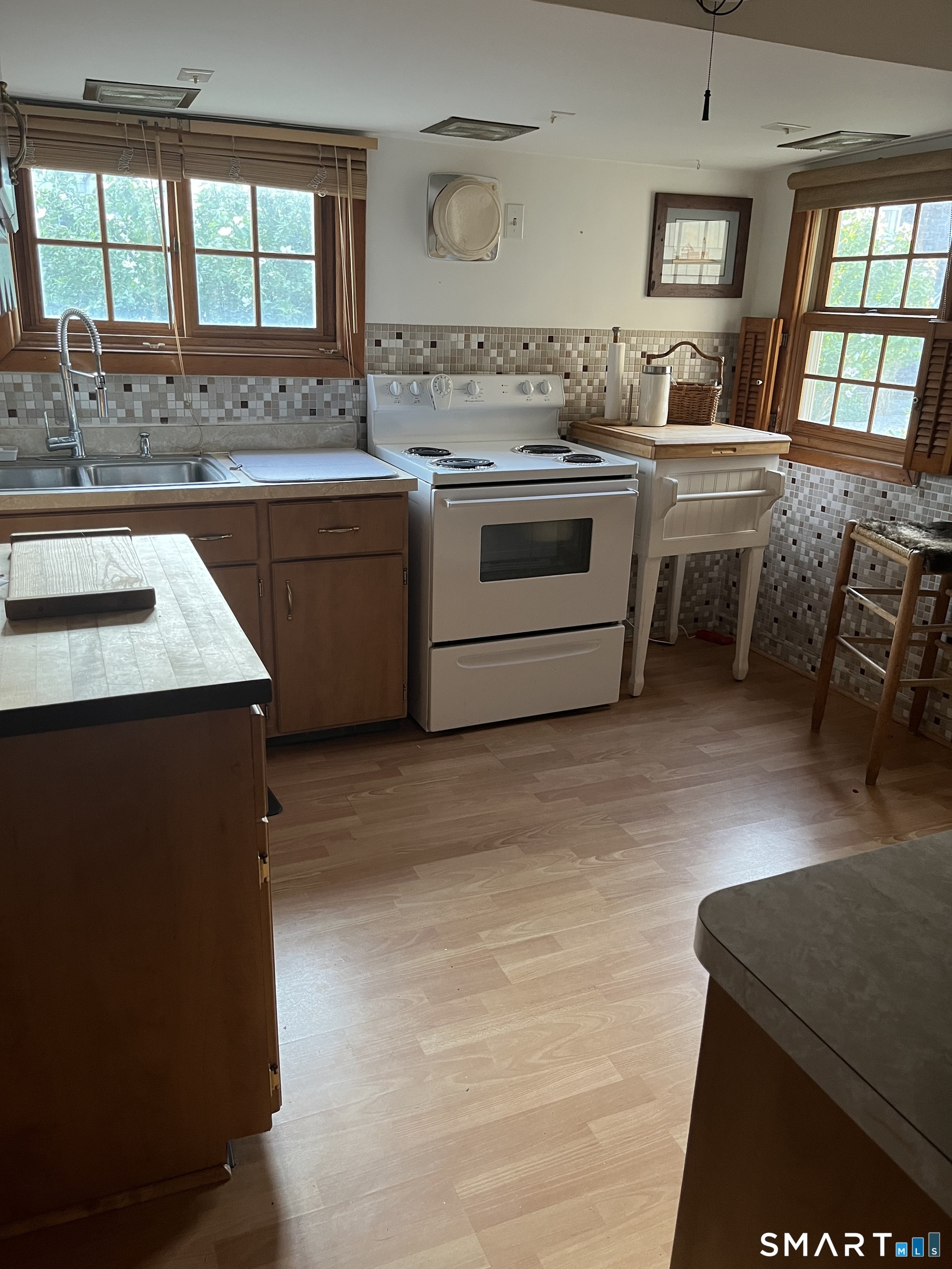 39 Little Bay Lane Branford, CT 06405 - Photo 11 of 20 a kitchen with stainless steel appliances granite countertop a stove a sink and a refrigerator