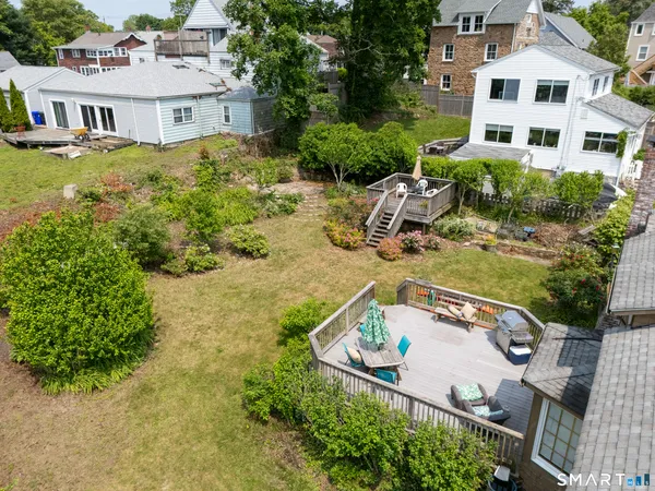 an aerial view of a house with yard swimming pool and outdoor seating