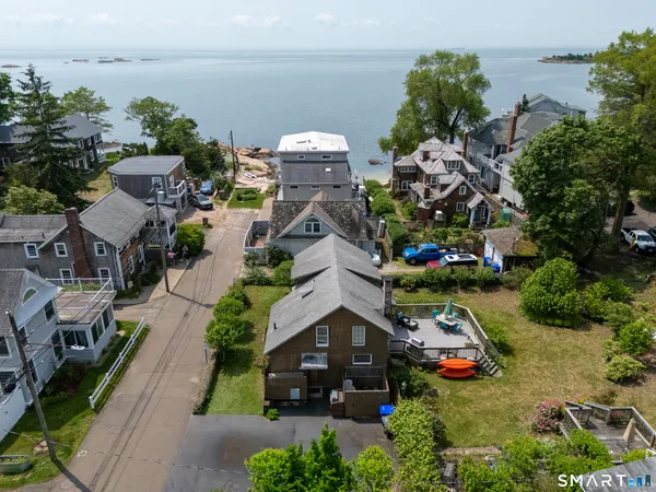 a aerial view of a house with garden space and lake view