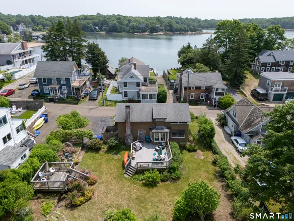an aerial view of multiple houses with yard