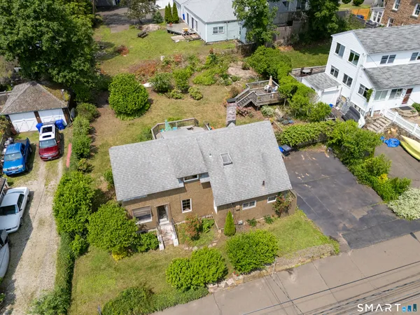 an aerial view of residential houses with outdoor space and parking