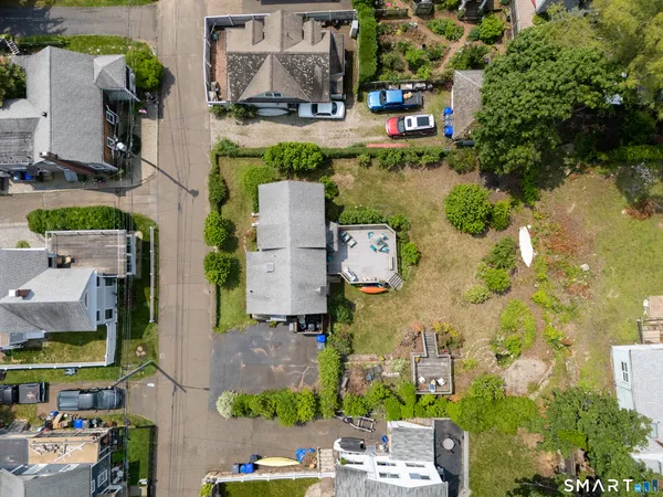 a front view of a house with a yard and potted plants