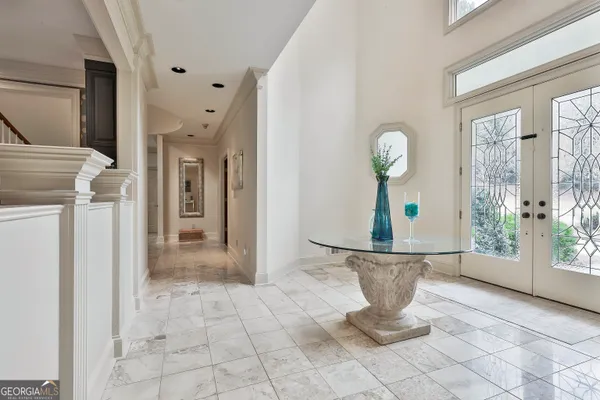 a living room with furniture and large windows