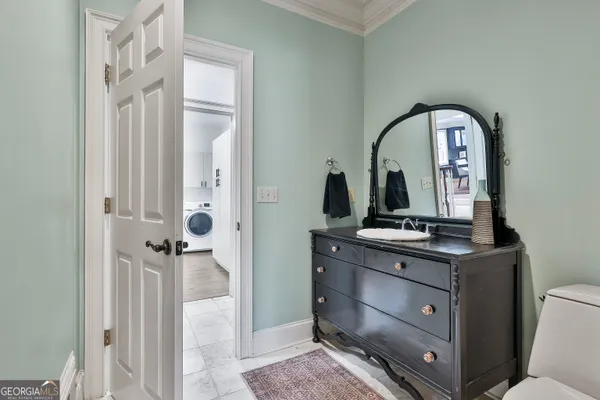 a living room with stainless steel appliances kitchen island granite countertop furniture wooden floor and a kitchen view