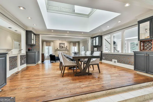 a bedroom with a large bed and wooden floor