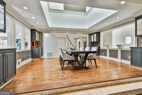 a view of a hallway with wooden floor and staircase