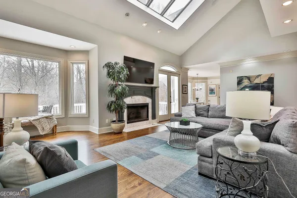 a bathroom with a granite countertop sink a toilet and a mirror