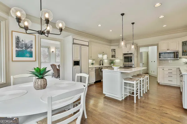 a view of a patio with table and chairs with wooden floor and fence