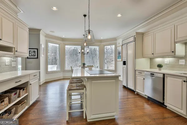 a kitchen with stainless steel appliances a stove a sink and a refrigerator