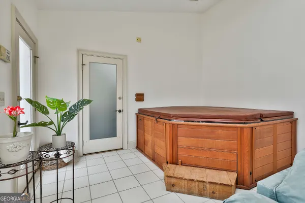 a view of swimming pool with outdoor seating and house in the background
