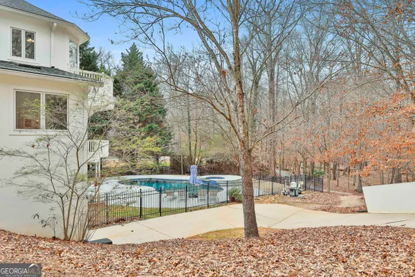 a view of a hallway with furniture and windows