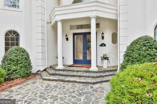 a view of bathroom with a toilet a sink and a mirror
