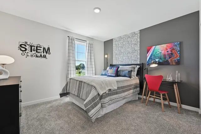 a spacious bedroom with a bed and a flat screen tv