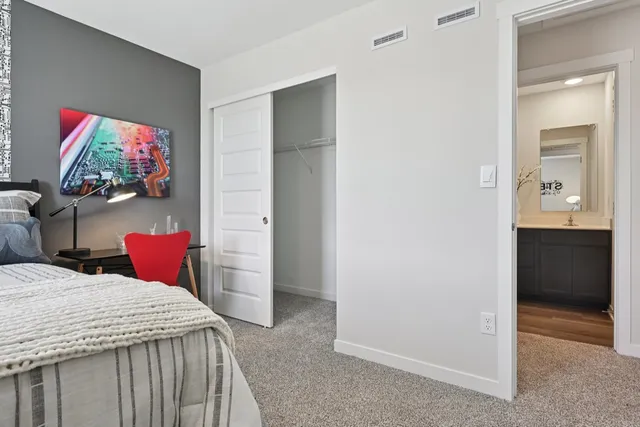 a bedroom with a bed and a flat screen tv