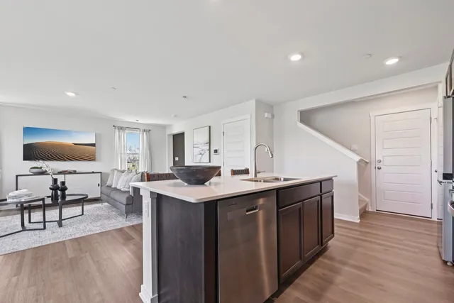 a view of a living room kitchen and a sink