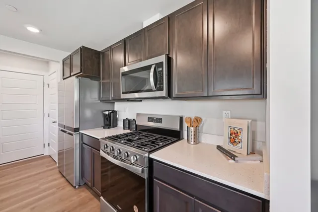 a kitchen with a sink stove and refrigerator