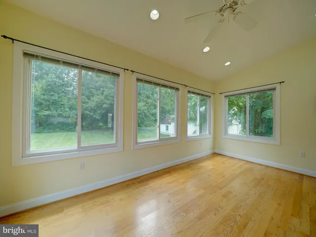 a kitchen with a sink a counter top space and living room area