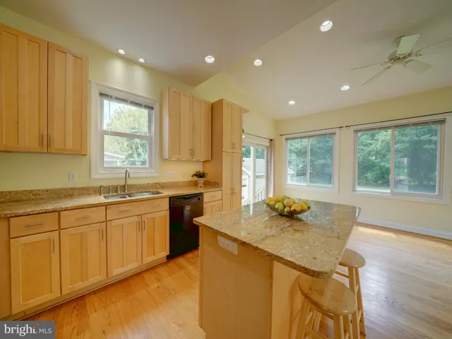a view of a room with wooden floor and a bathroom
