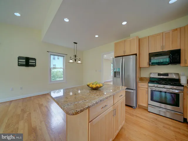 an empty room with a window and ceiling fan
