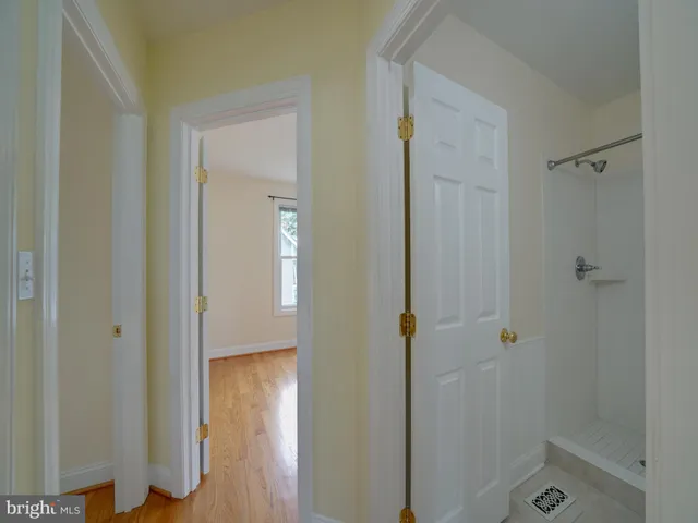 an empty room with windows and closet