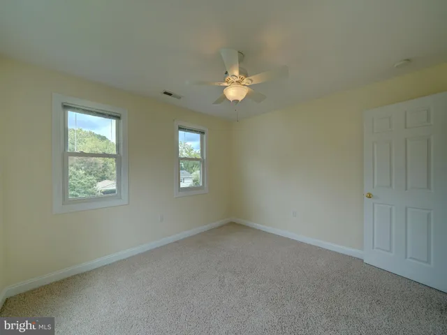 a view of a house with a small yard and flower plants