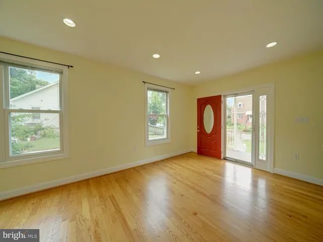 a view of a kitchen and dining room with wooden floor
