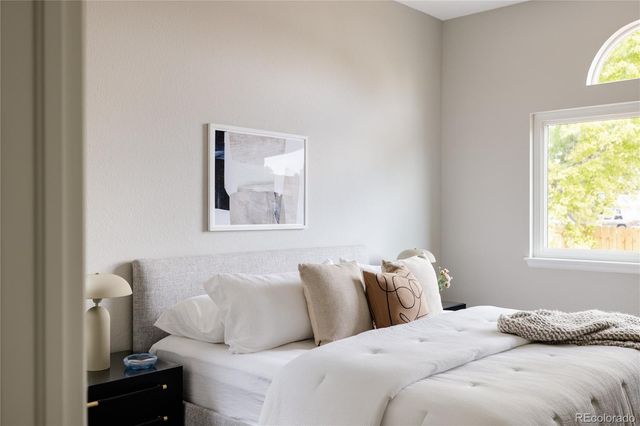 a bedroom with bed and window