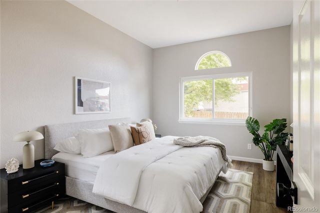 a bedroom with a bed and a potted plant