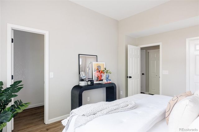 a bedroom with a bed and a potted plant