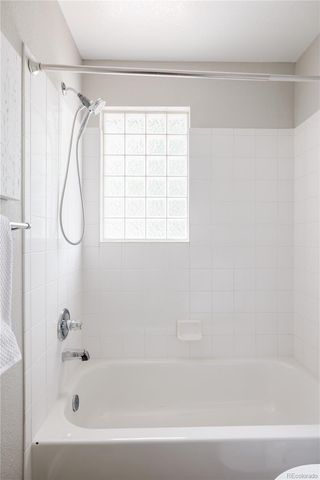 a bathroom with a bath tub with a shower